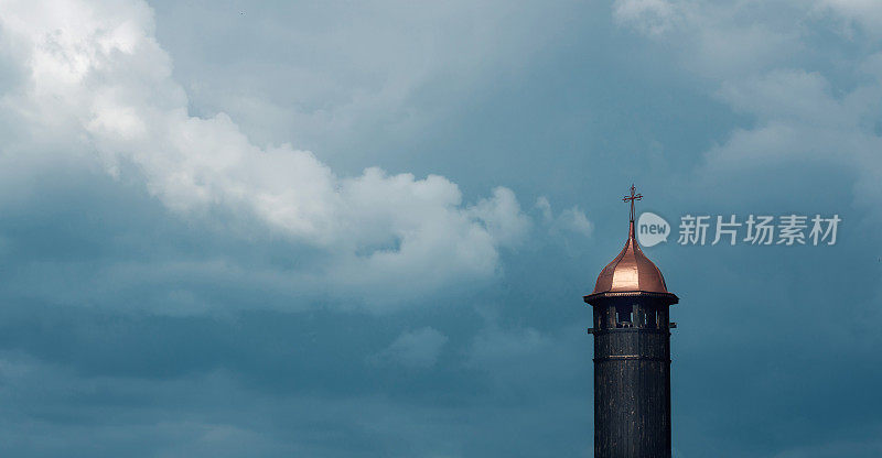 Church tower against dramatic sky background